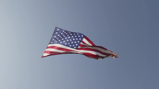 A large American Flag against a blue sky, Pleasant Grove, UT