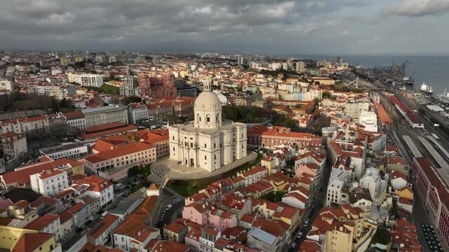 Top aerial view of Lisbon historic districts Alfama and Gra&ccedil;a with scenic river 