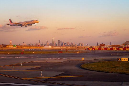 Newark Liberty Airport, Newark, New Jersey, USA - November 19, 2023 - American Airlines Airbus A321 approaches landing at Newark Liberty International Airport, New Jersey, during golden hour