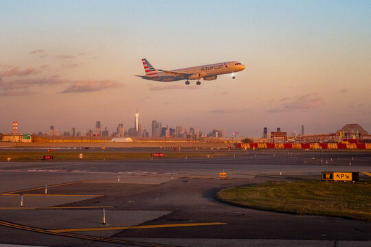 Newark Liberty Airport, Newark, New Jersey, USA - November 19, 2023 - American Airlines Airbus A321 approaches landing at Newark Liberty International Airport, New Jersey, during golden hour
