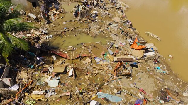 Destroyed homes and muddy river show climate migration pressure Cebu