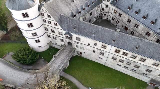 Drone looks down on the entrance bridge from above the gate with a slight right to left orbit.