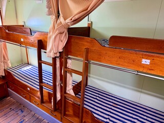 Majestic view of the tall ship Kaiwo Maru and Shinminato Bridge against the snowy Tateyama Mountains in Toyama, Japan.