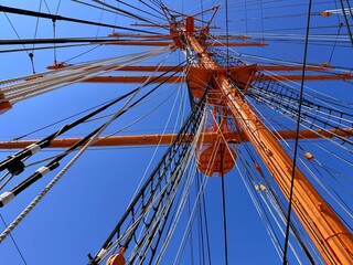 Majestic view of the tall ship Kaiwo Maru and Shinminato Bridge against the snowy Tateyama Mountains in Toyama, Japan.