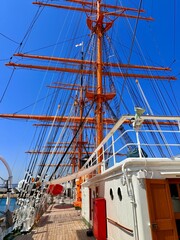 Majestic view of the tall ship Kaiwo Maru and Shinminato Bridge against the snowy Tateyama Mountains in Toyama, Japan.
