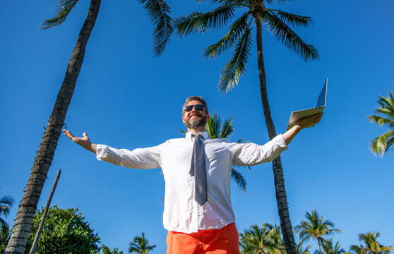Businessman on summer. Online freelance work. Successful businessman worker. Vacation work setup. Business man using laptop among palm tree. Business trip success. Man freelance worker online