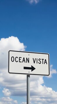 Ocean Vista Sign Pointing Towards Scenic Coastal Views Under Bright Sky