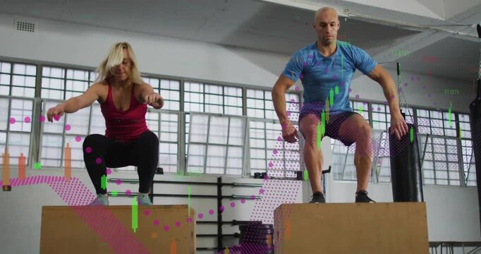 Vertical video: Swinging arms man and red tank woman training box jumps in gym with plyo boxes