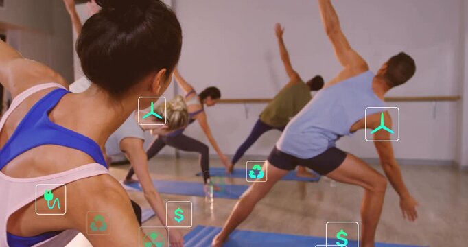 Coach cueing class entering deep lunge in fitness studio, eco and dollar icons popping over mats