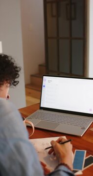 Vertical video: Receiving prompt, nonbinary artist drawing layout with pencil at desk, copy space
