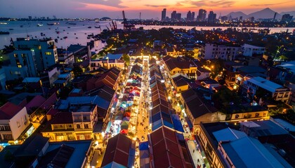 Fototapeta premium Aerial View of Cityscape at Dusk with Illuminated Streets.