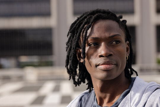 African american man standing wearing jacket over shirt near plaza, copy space