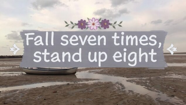 Inspiring Japanese proverb Fall seven times, stand up eight on a sign at the beach, symbolizing resilience, perseverance, and never giving up.