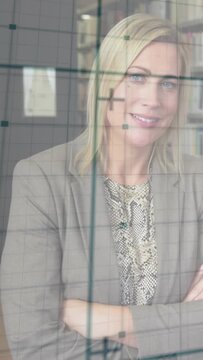 Vertical video: Woman tilting head behind glass grid, camera shifting grid across face for design