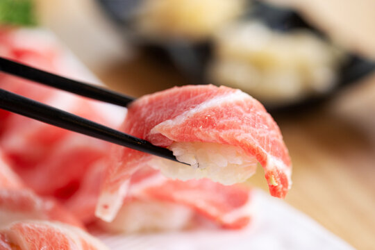Tuna sushi on chopsticks