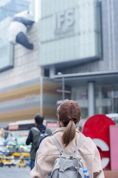woman traveler travel in Chengdu city. Happy Tourist sightseeing in Chunxi Road, located in the Jinjiang District. Famous landmark for tourism attraction in Sichuan, China