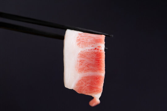 Tuna sashimi on chopsticks
