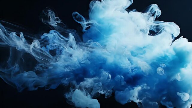 Abstract cloud of white and blue ink swirling in dark liquid creating smoke effect