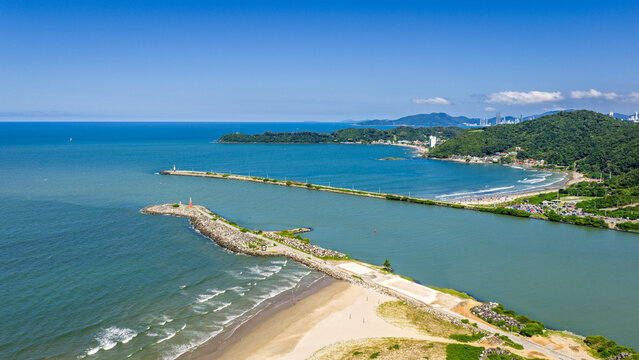 Aerial view of Itajai breakwater and Navegantes lighthouse with turquoise sea and green hills, Santa Catarina.