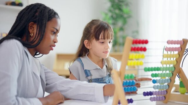 African tutor use educational abacus help a child learn basic math skill. 