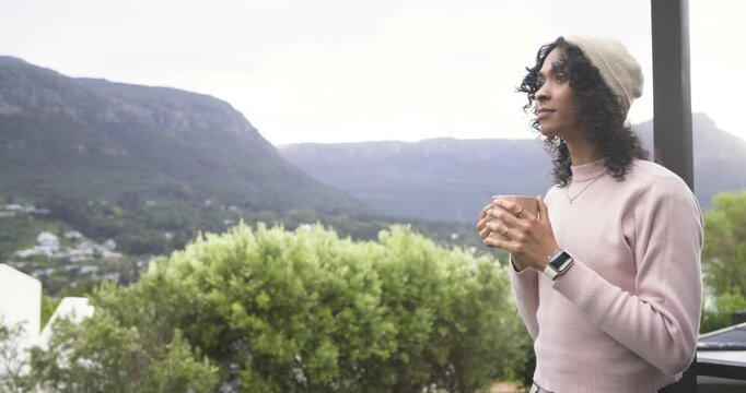Approaching balcony, non-binary adult lifting mug, inhaling air to enjoy view, copy space