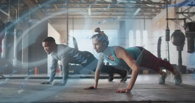 Vertical video: Following onscreen prompt pair doing push-ups in sync on gym rubber mat in gym gear