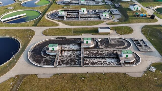 Aerial drone view of a modern wastewater treatment plant with aeration tanks and sedimentation basins. Professional water management infrastructure, ecology, and environmental protection in an industr