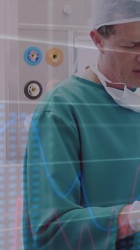 Vertical video: Surgeon adjusting device, gloved hands activating HUD charts by outlets for surgery