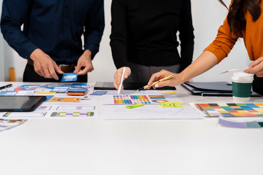 UX developer and ui designer brainstorming about mobile app interface wireframe design with customer breif and color code, User experience concept.