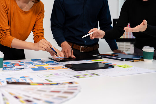 UX developer and ui designer brainstorming about mobile app interface wireframe design with customer breif and color code, User experience concept.
