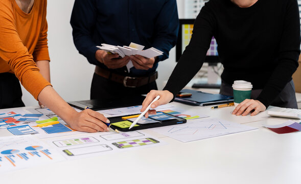 UX developer and ui designer brainstorming about mobile app interface wireframe design with customer breif and color code, User experience concept.
