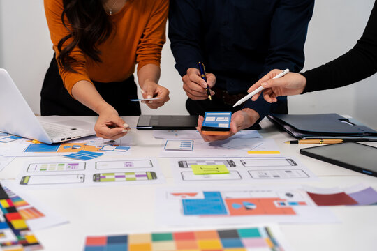 UX developer and ui designer brainstorming about mobile app interface wireframe design with customer breif and color code, User experience concept.