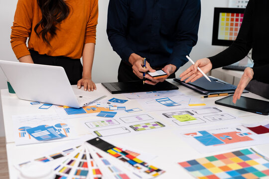 UX developer and ui designer brainstorming about mobile app interface wireframe design with customer breif and color code, User experience concept.