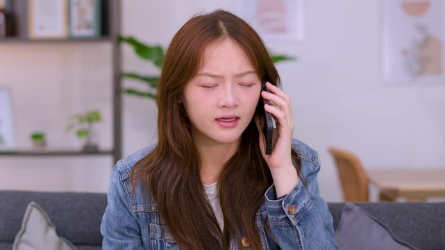 Angry Young Asian Woman Having Argumentative Phone Call in Living Room