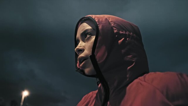 Woman, runner and fitness at night in city with rest, breathing and low angle for cardio training. Girl, outdoor and break for perspective, sprint or launch for running with exercise in dark town