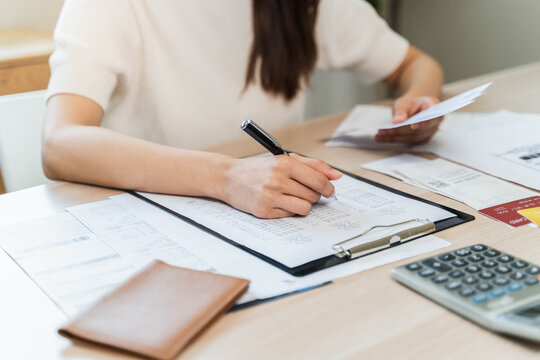 person using calculator calculating tax refund on the table