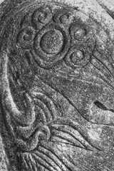 Naklejka premium Black and white close-up of traditional Korean stone carving with intricate cloud and floral patterns