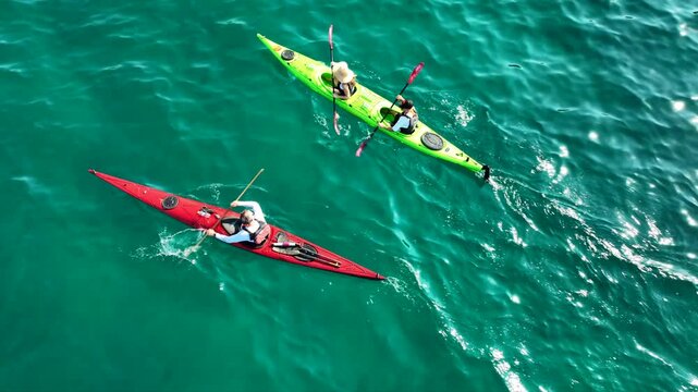 Aerial drone top down cinematic video of athletes practice sport canoe in tropical exotic island emerald crystal clear calm sea