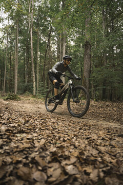 Mountain biker on a leaf-covered trail
