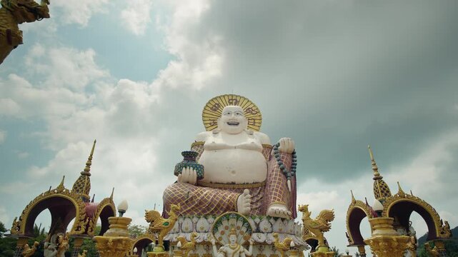 Big Buddha statue surrounded by ornate temple decorations at Wat Plai Laem on Koh Samui island in Thailand