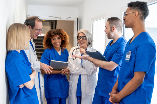 Diverse medical team collaborating in hospital hallway
