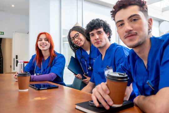 Medical students smiling during coffee break in hospital