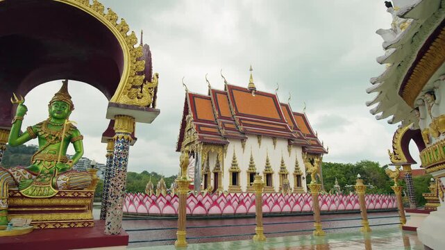 Thai temple at Wat Plai Laem with green deity statue and ornate architecture on Koh Samui in Thailand