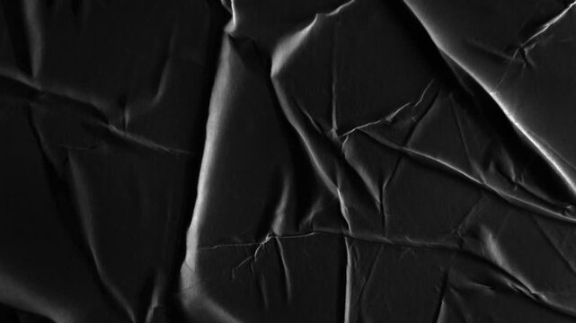 Seamless looping black crumpled paper background texture, video 4k resolution	