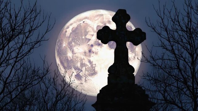 Spooky graveyard scene with a cross silhouette against a giant full moon at night. Gothic cemetery landscape with bare trees for a scary halloween or horror concept