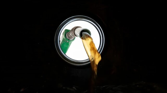 Nozzle pumping gasoline in a tank