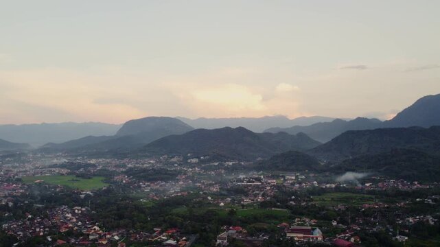 Airborne sideward flying view of the city of Luang Prabang during the evening hours.