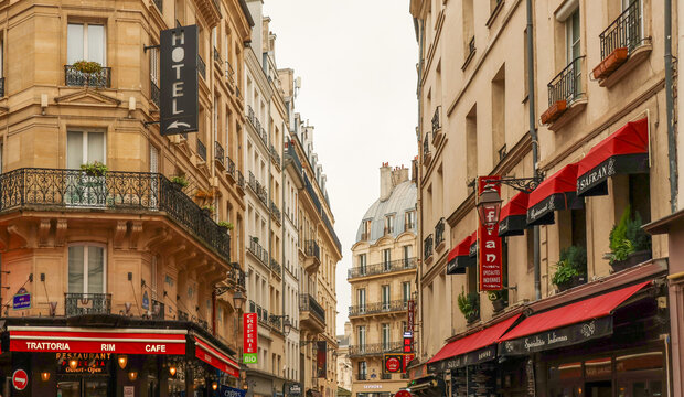 Paris, France October 13, 2025. Paris street with hotel and restaurant signs enticing travelers and tourists