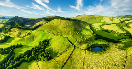 Naklejka premium Aerial view of beautiful lagoon in the Azores islands. Drone landscape view with lines and textures in the background. Top view of volcanic crater, tourist attraction of Portugal.