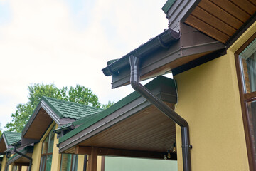 Part of the building cornice and drainage system of the building. semicircular gutter with a drainpipe. © Andrey